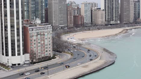 aerial of oak street beach with lakefront road traffic, chicago