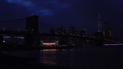 El-Horizonte-De-La-Ciudad-De-Nueva-York-Con-El-Puente-De-Brooklyn-En-Primer-Plano-Por-La-Noche