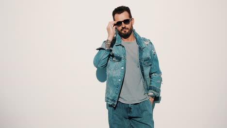 stylish man in denim jacket and sunglasses