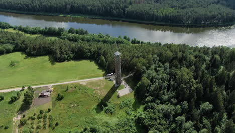 Observation-tower-of-Birstonas-near-Nemumas-river,-aerial-drone-orbit-view