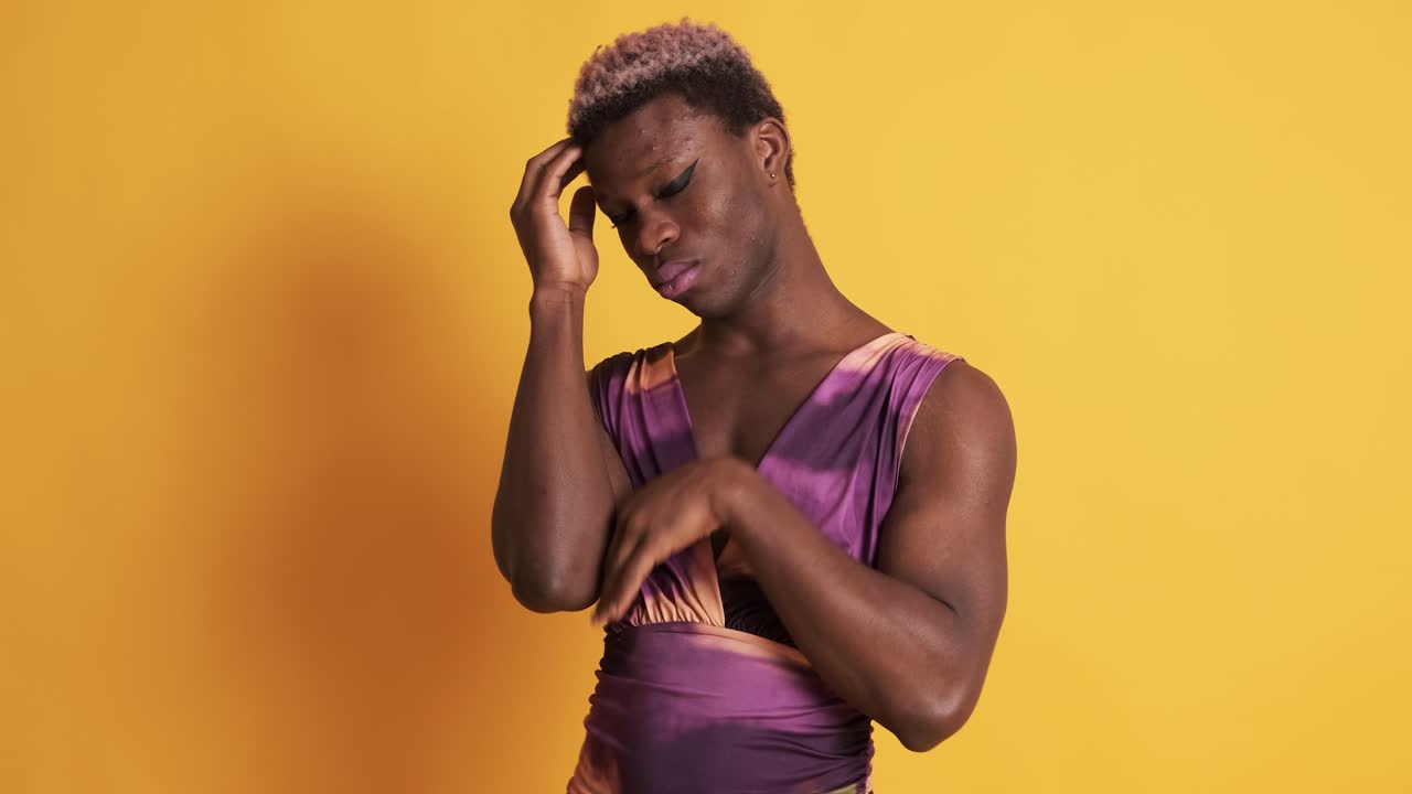 Worried african transgender man in a yellow background