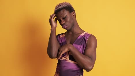 worried african transgender man in a yellow background