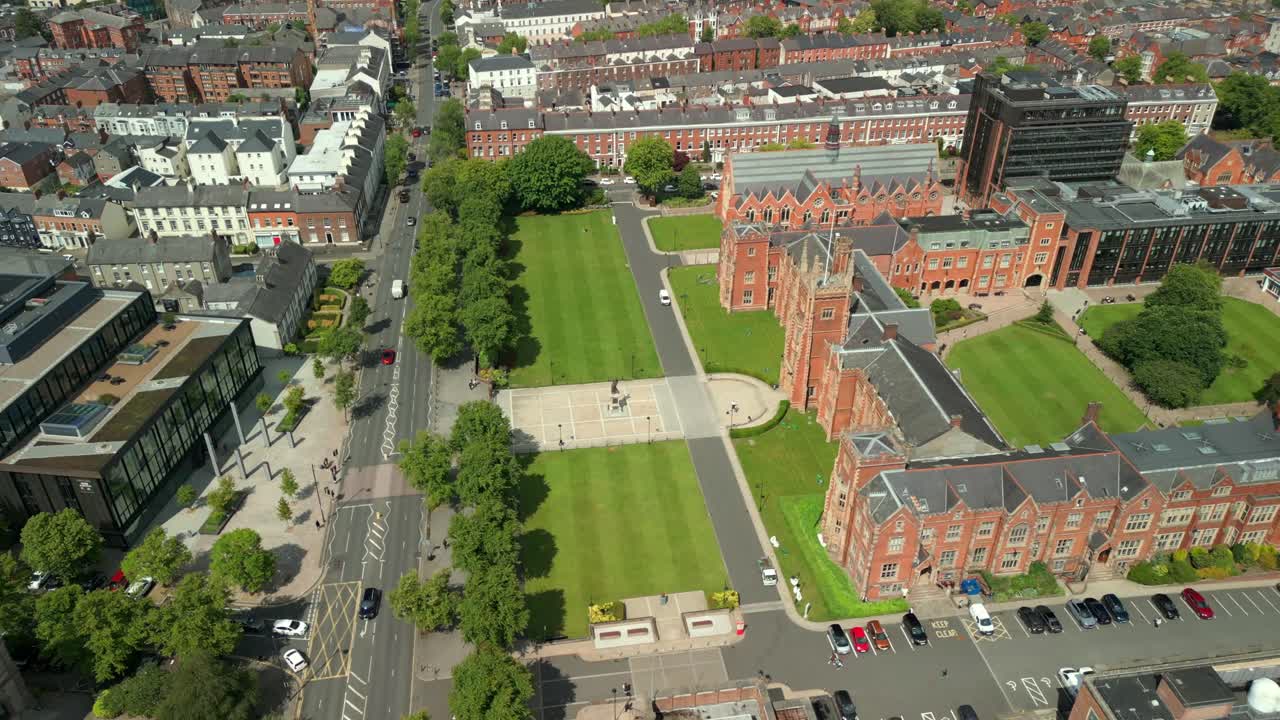 Side-on and advancing aerial video of Queen's University Belfast, in Northern Ireland, UK on a bright and sunny day. Produced at 4K resolution, 60FPS and with Rec709 color.