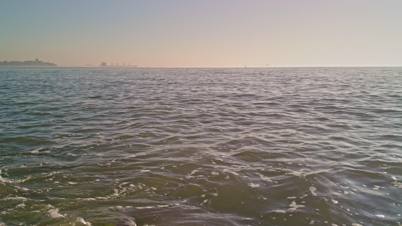 beautiful and romantic view from sunny seashore to the North sea ocean in Europe with water waves and sunlight