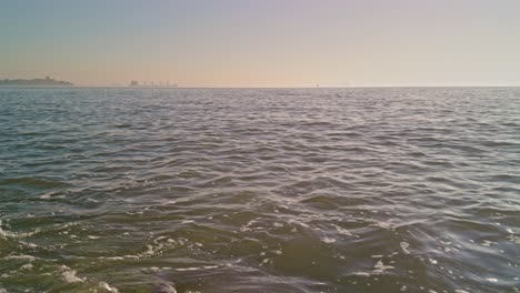 beautiful and romantic view from sunny seashore to the north sea ocean in europe with water waves and sunlight
