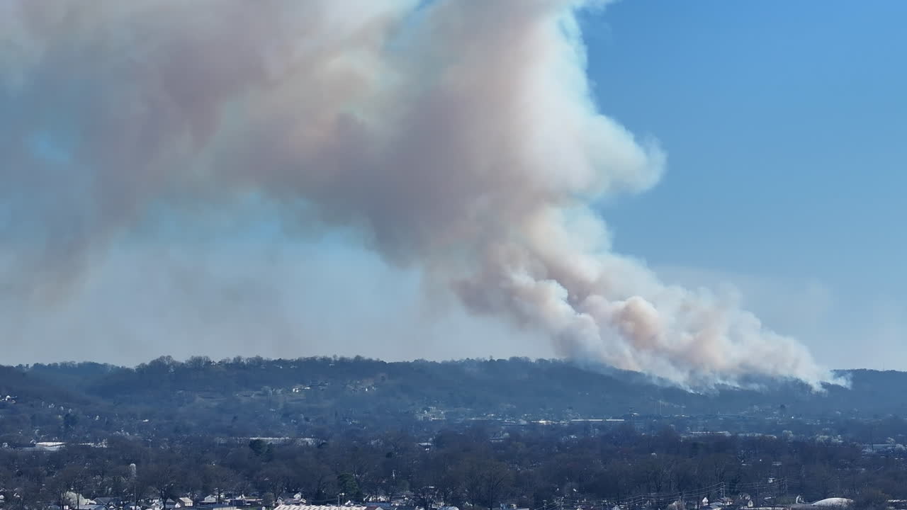 Telephoto footage of the smoke of a forest fire that is happening on a ridge in northern Georgia.