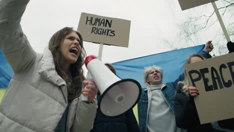 group of young caucasian people manifesting against conflict in ukraine.