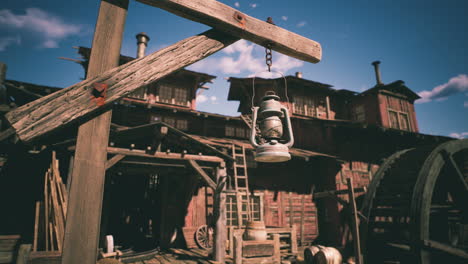 vintage lantern hanging in a rustic western town during bright daylight