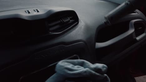 man sanitizing car dashboard with steam