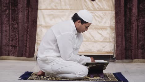 Indian-muslim-man-reading-Quran-book-at-home