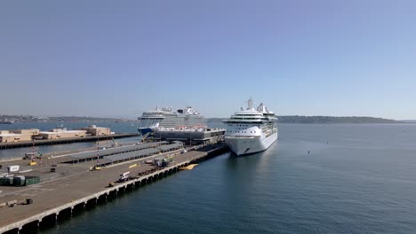 aerial view of two large white cruise ships waiting for tourists before departing from seattle, wa usa