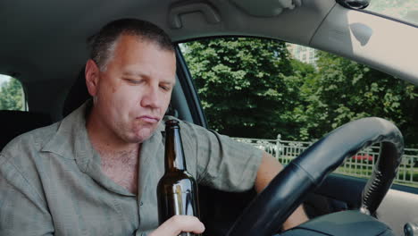 the driver drinks alcohol at the wheel dangerous illegal behavior concept