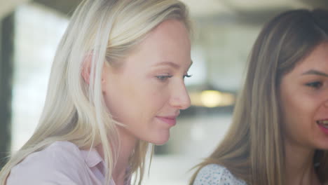 Three-Businesswomen-Meeting-In-Coffee-Shop-Shot-Through-Window