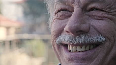 Elderly-Man-With-Gray-haired-Mustache-Laughing-In-Front-Of-Camera