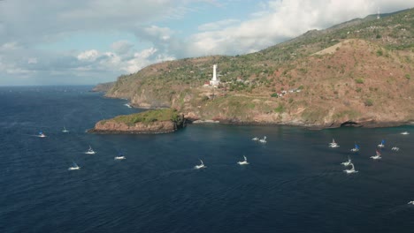 returning fishing boats moving towards coast of bali, coming home, aerial