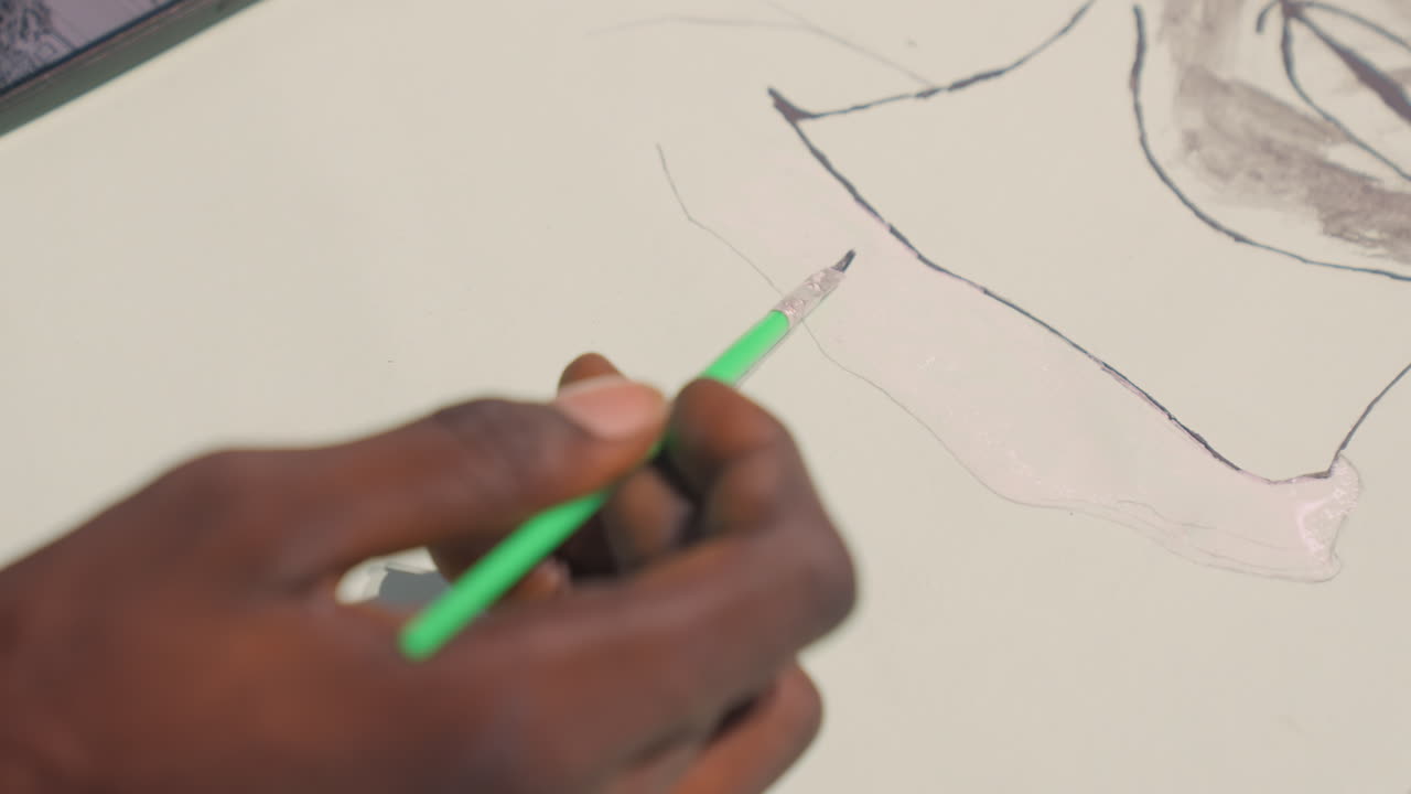 Refined artistic detail. Refining contours with subtle shading. Meticulous finishing on detailed black and green artwork. Precise edge work highlighting shadows and light in studio setting
