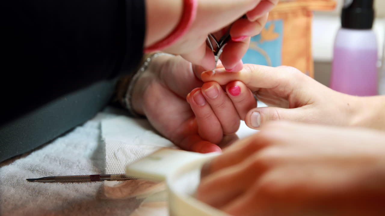 Nail technician giving customer a manicure