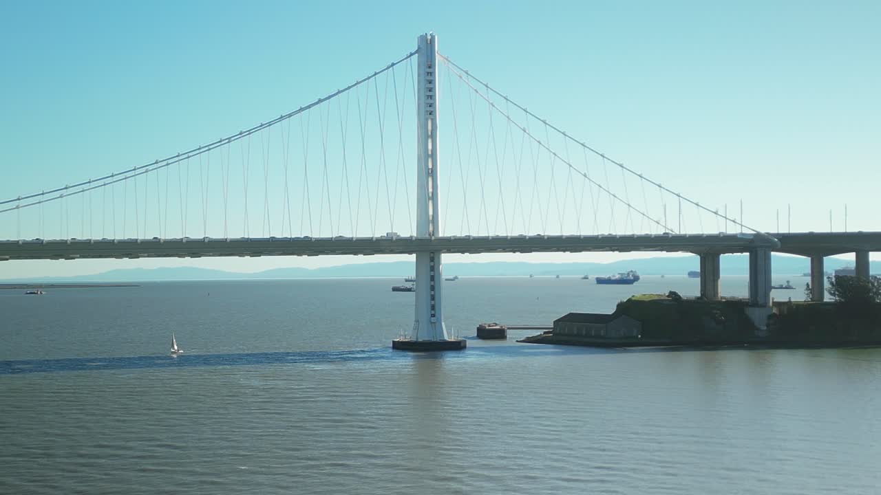 Static drone shot close to San Francisco-Oakland Bay Bridge with blue sky in California, USA