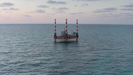 offshore platform in the ocean at sunset