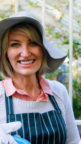 mature woman holding watering can