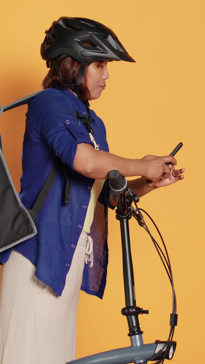 A woman with a bicycle and a helmet