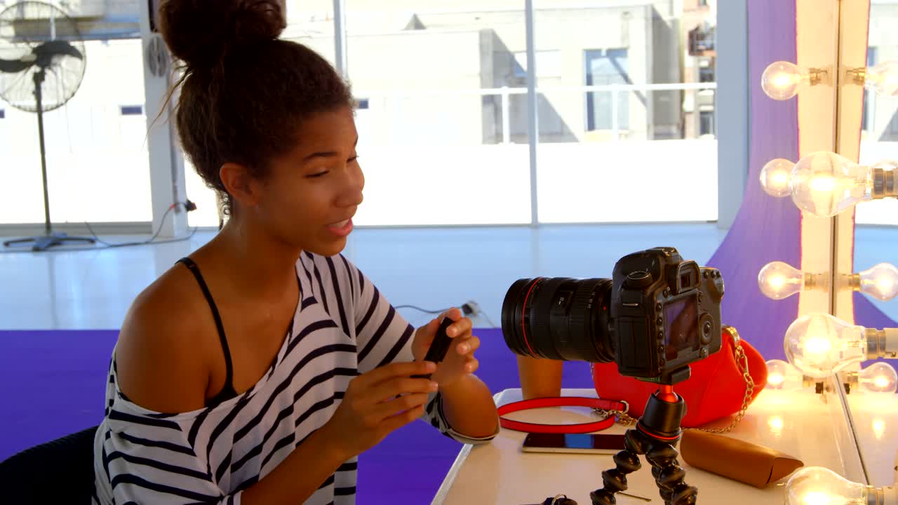 Model applying make up in photo studio 4k