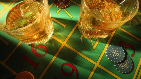 Whiskey and Roulette Chips on a Casino Table