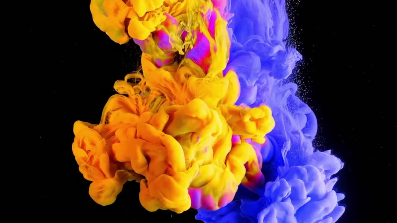 Pink, blue and yellow ink splash in water