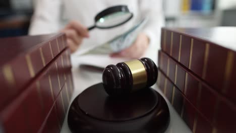 judge counts money on the court gavel table closeup