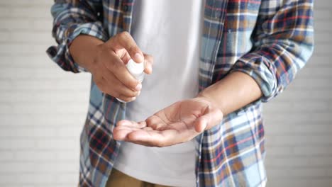 person applying hand sanitizer