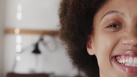 portrait of happy biracial female worker in workshop in jewellery studio in slow motion
