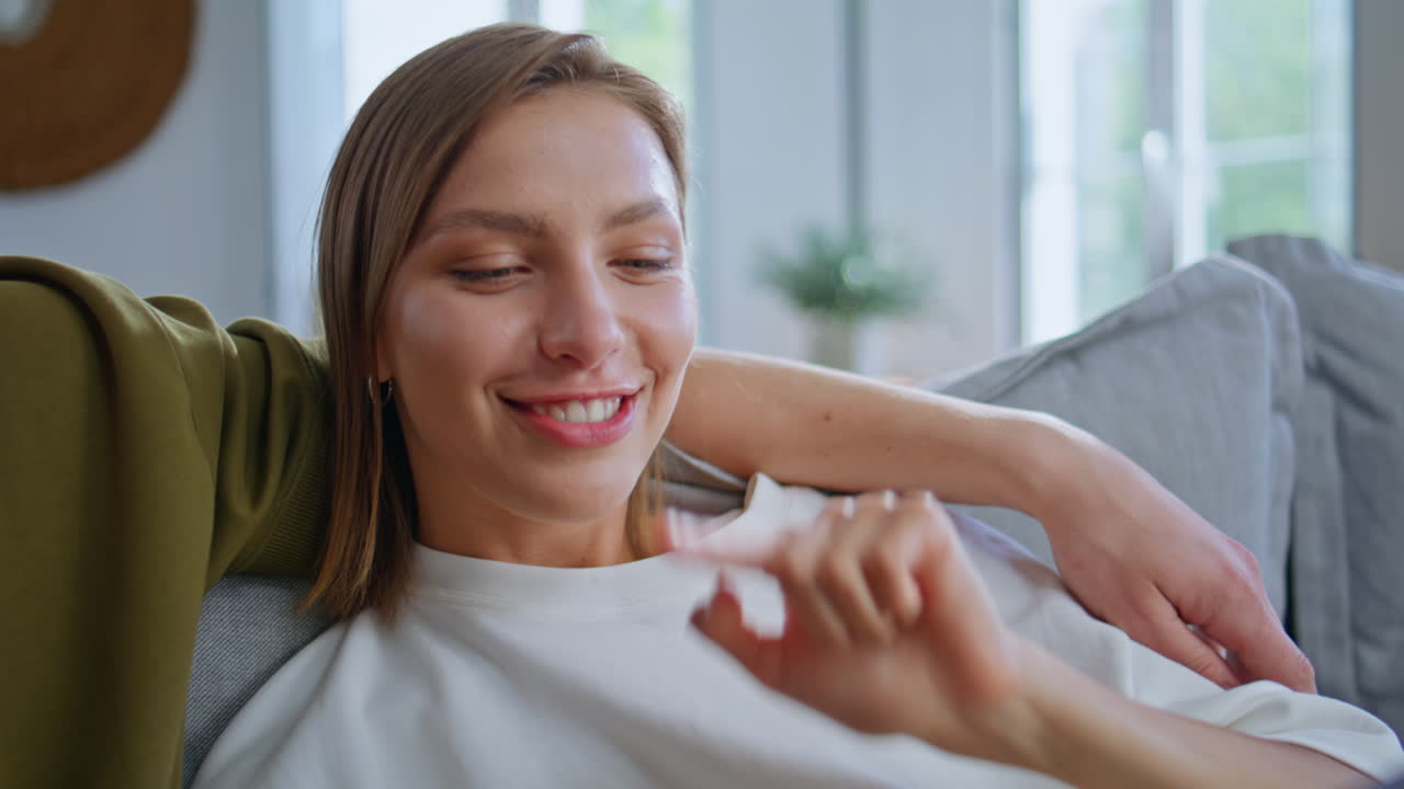 Inspired girlfriend talking boyfriend shopping online on tablet at home closeup