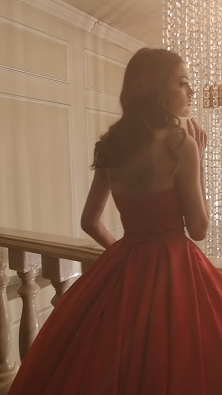 Woman in a Red Ball Gown on a Grand Staircase
