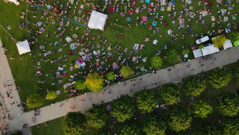 aerial view above a people sitting on lawn listening to music in louisville, kentucky, usa - top down, drone shot