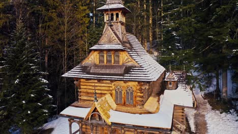 drone aerial close up dolly shot of the jaszczurówka chalep - zima tatra mountains in winter