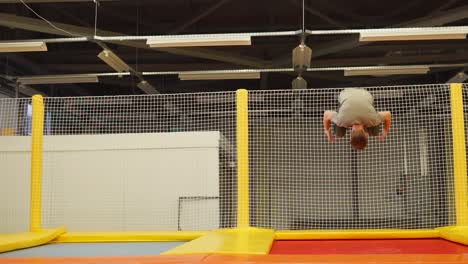 person performing a flip on a trampoline