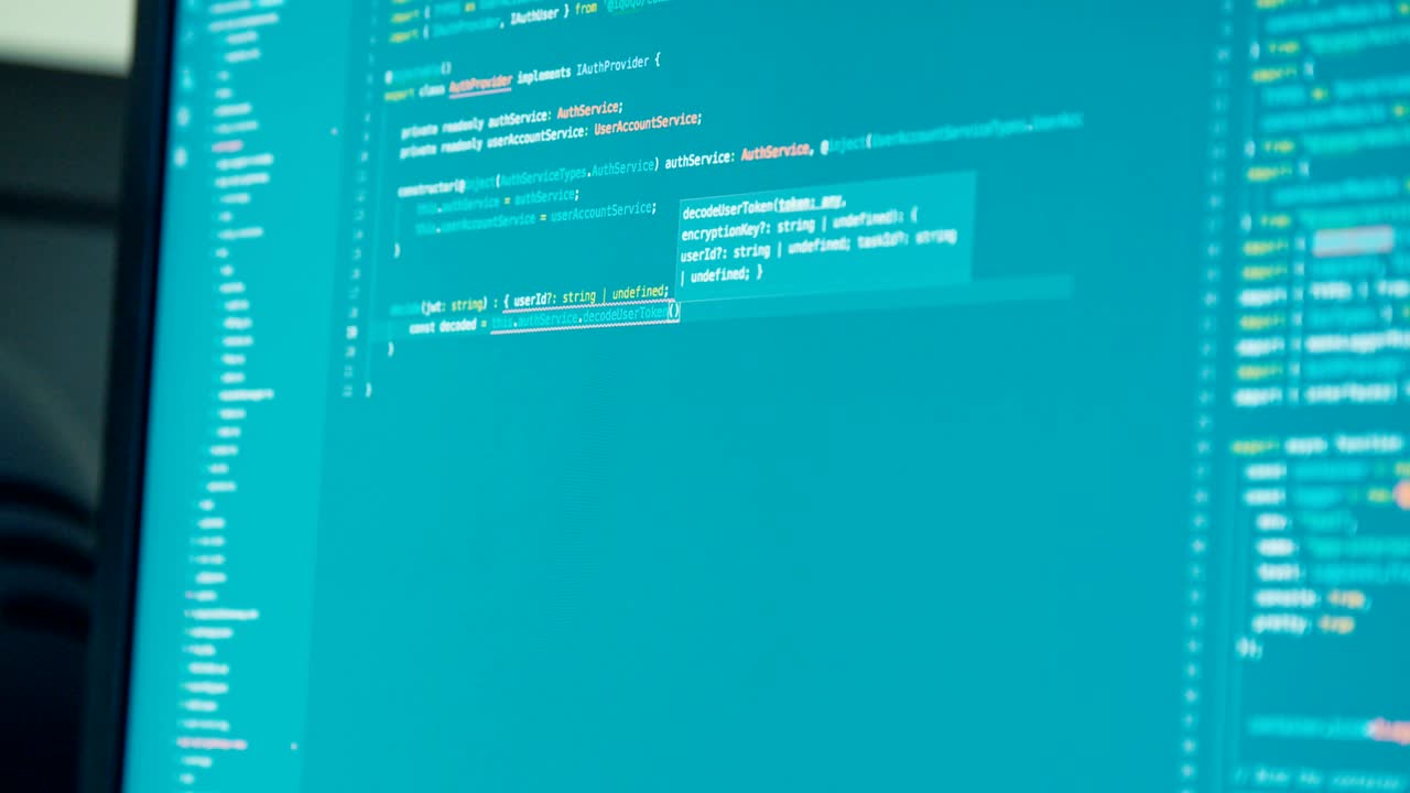 computer programmer sitting in front of a screen coding software