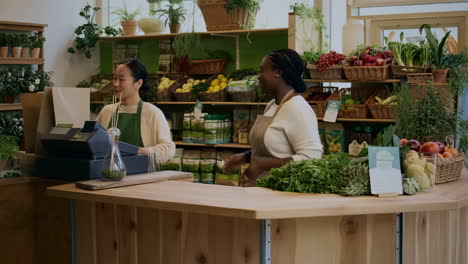 two women working at a fresh produce or grocery store counter