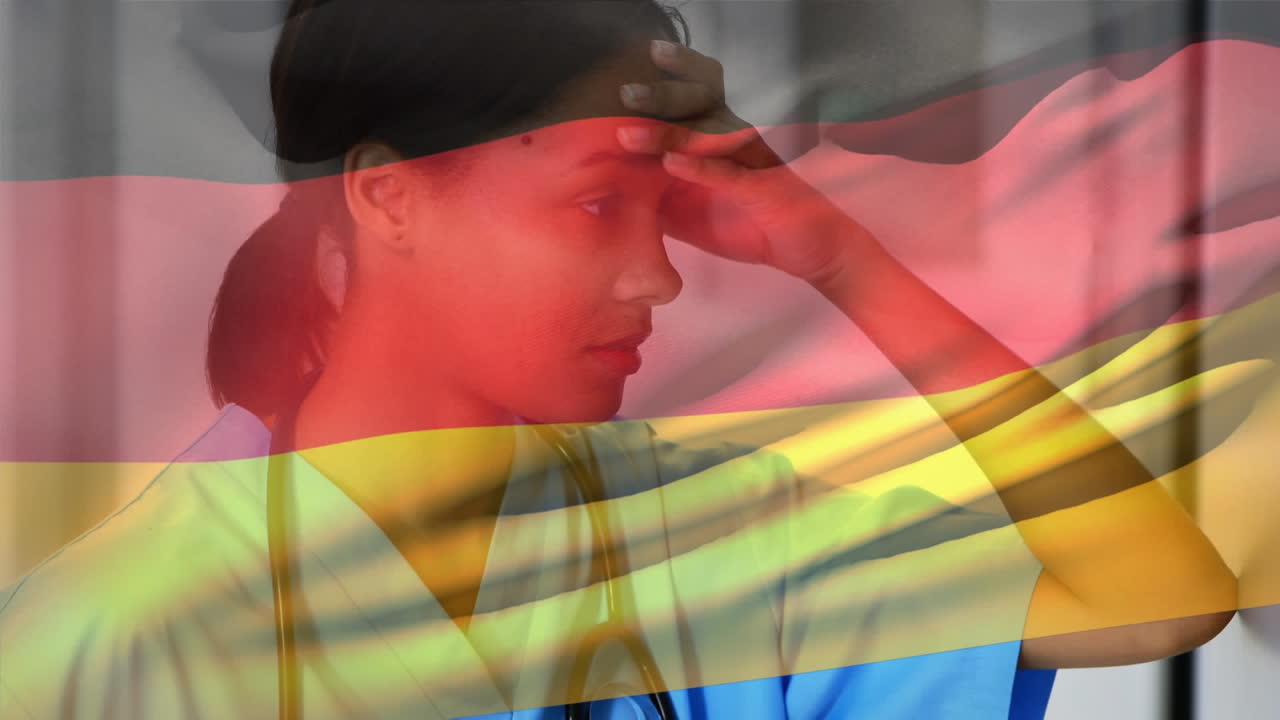 флаг германии размахивает против стрессовой афроамериканской работницы здравоохранения в больнице