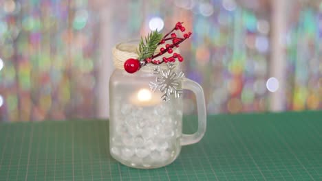 diy candle holder jar with decorative christmas themed ornaments