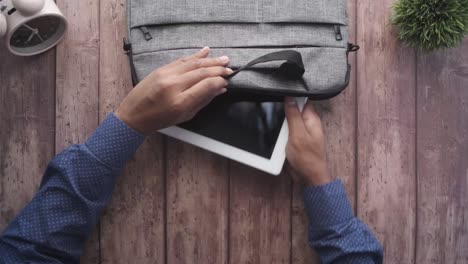 person preparing for work with laptop bag.