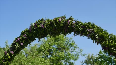 floral wedding arch from lilac on sky background