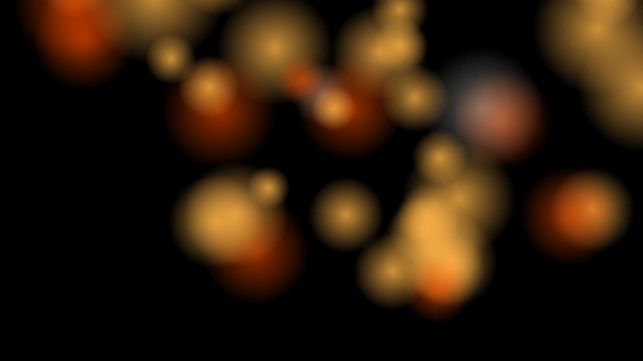 Abstract Golden Bokeh Lights Floating on Black Background