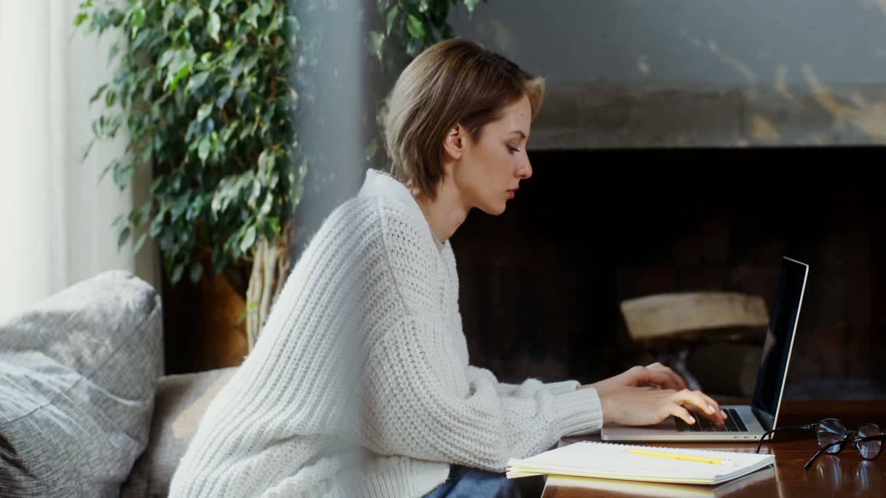 Woman Working on Laptop at Home