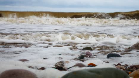 foamy breaking ocean surf pebble beach shoreline tide soothing multicoloured stones left dolly