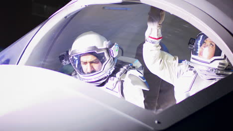 astronauts in cockpit of futuristic spaceship