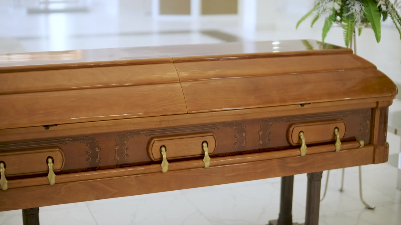 Polished Wooden Casket Resting in a Funeral Home