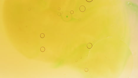 animation of bubbles moving on yellow liquid with copy space