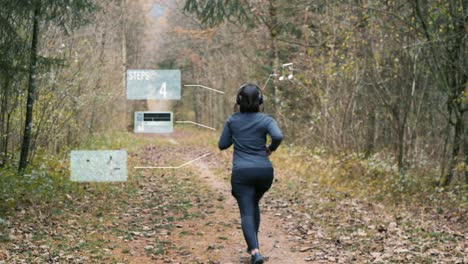 sporty woman puts on headphones and activates fitness app on her smartwatch for running through the autumn forest - animated holograms insert