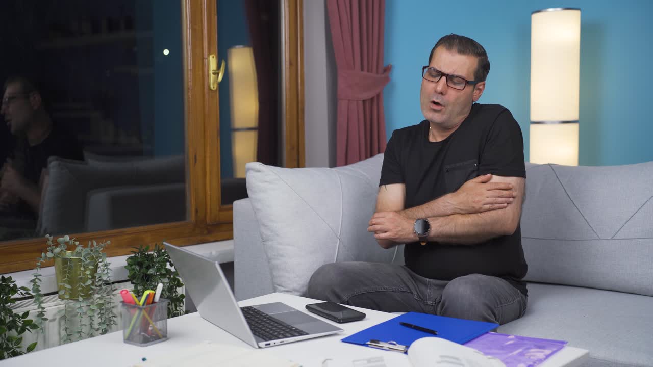 Home office worker man having a heart attack.